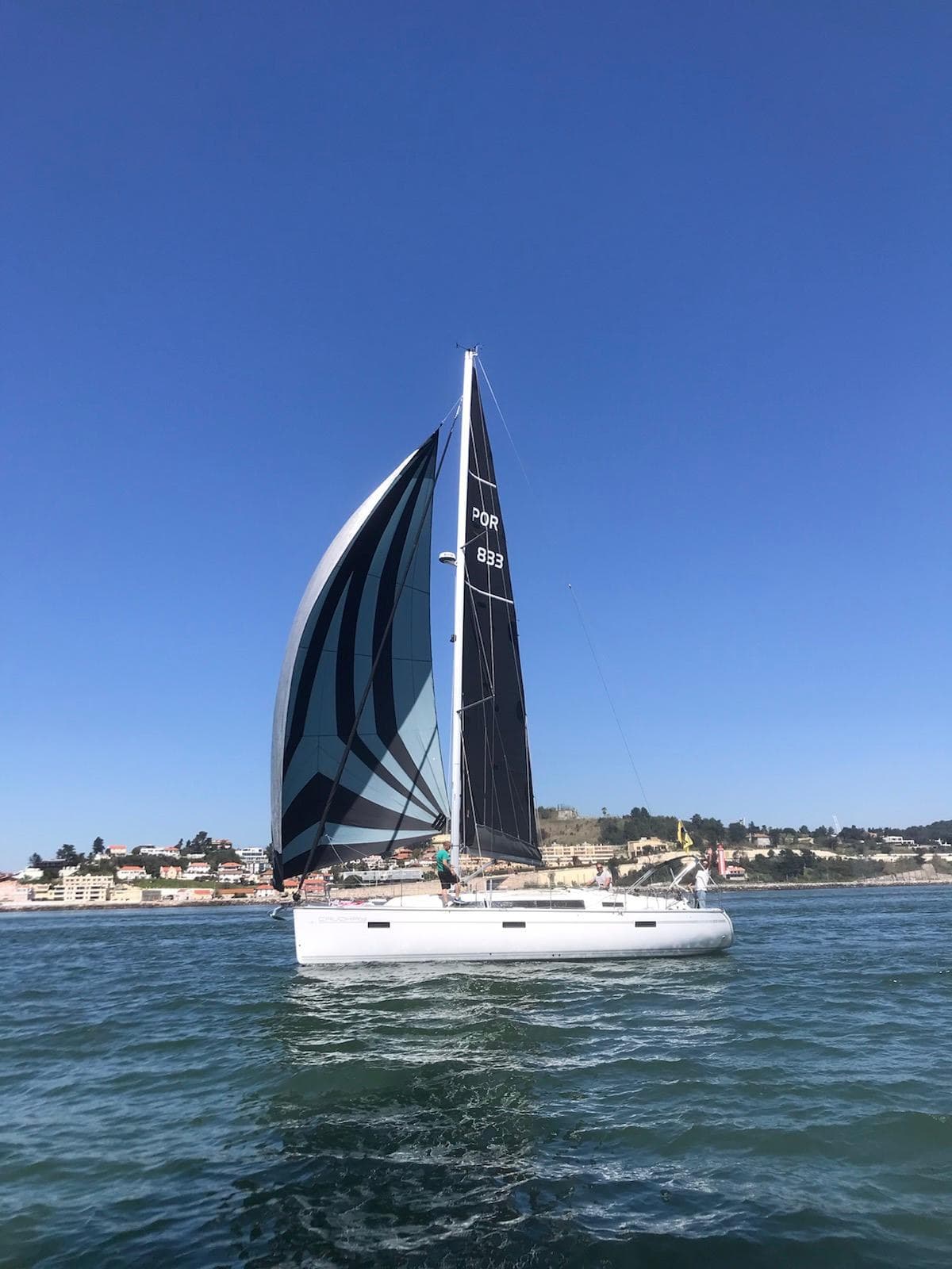 Bavaria 42 sailing yacht under full sails on the Tagus