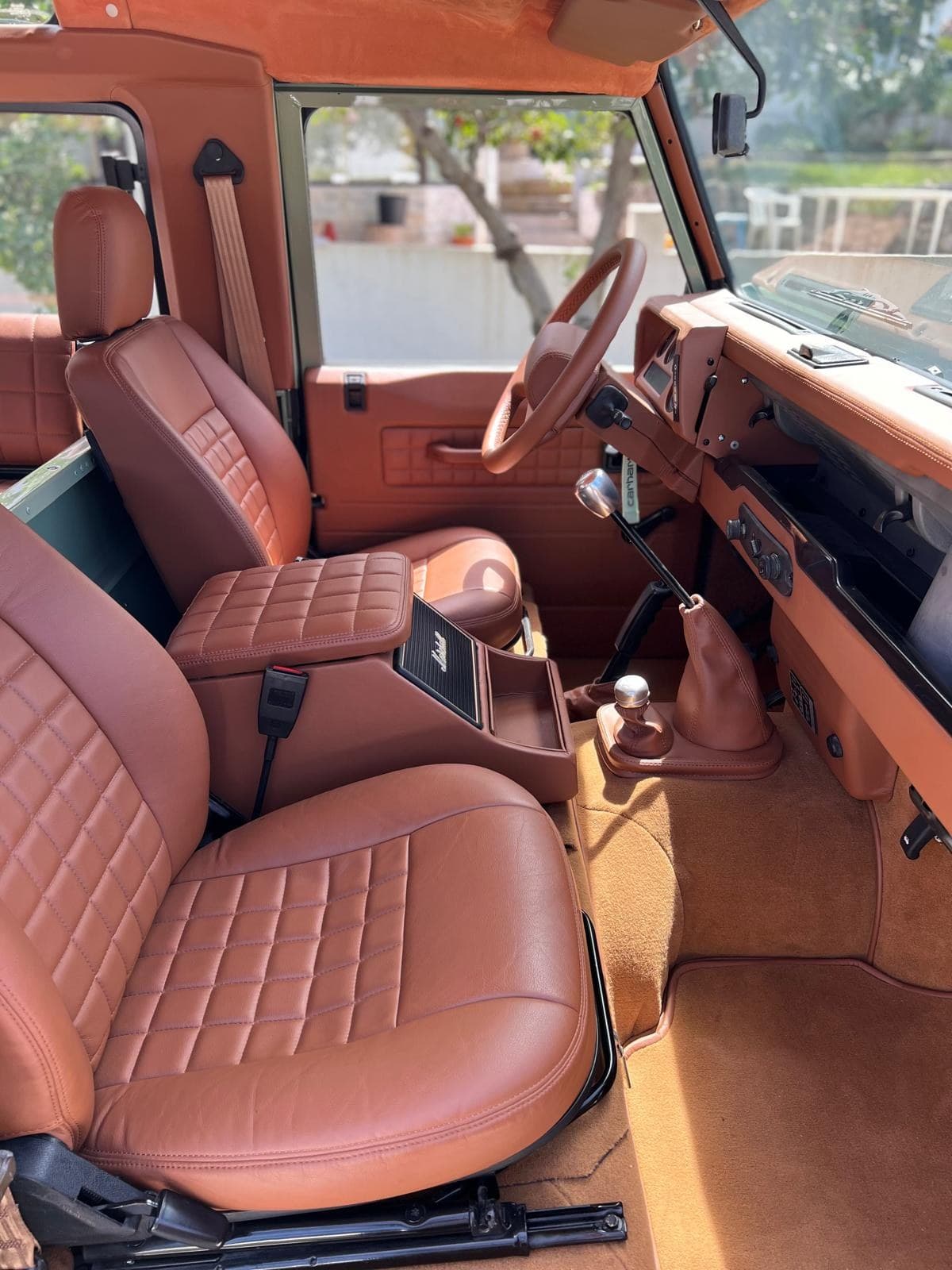 Interior of the Defender Heritage — tan leather, wood dash